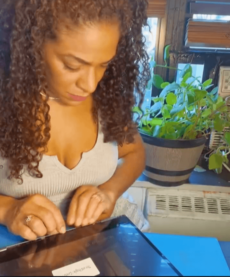Bianca Shillingford holding a device while teaching at Repair Babe Academy